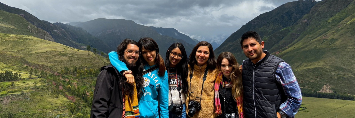 Group of students with mountains of Peru in the background